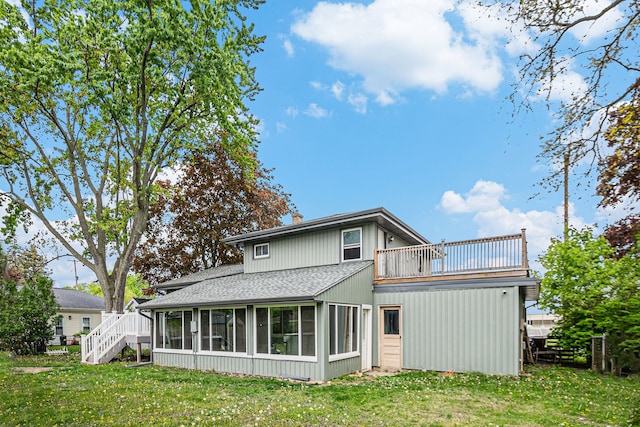 604 E N St, Owosso, MI 48867 - back of property with roof with shingles, a sunroom, a balcony, and a yard