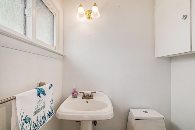 604 E N St, Owosso, MI 48867 - half bathroom featuring toilet and a sink