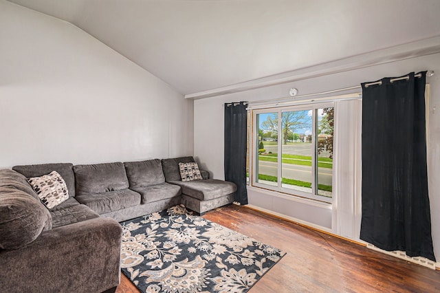 604 E N St, Owosso, MI 48867 - living area featuring vaulted ceiling and wood finished floors