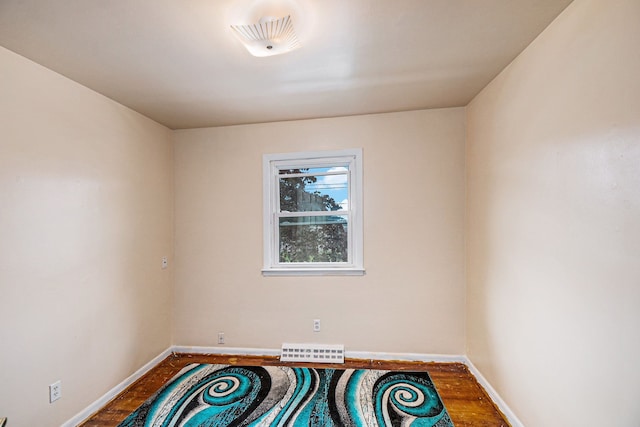 604 E N St, Owosso, MI 48867 - unfurnished room with wood finished floors and baseboards