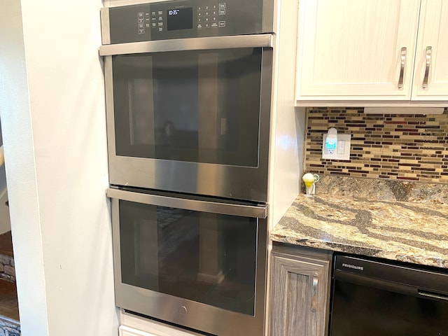 604 E N St, Owosso, MI 48867 - kitchen featuring double oven, black dishwasher, tasteful backsplash, and light stone countertops