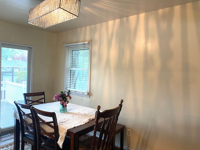604 E N St, Owosso, MI 48867 - dining space featuring plenty of natural light, a chandelier, and baseboards