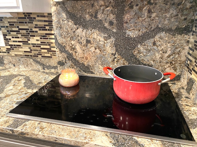 604 E N St, Owosso, MI 48867 - kitchen view of tasteful backsplash and black electric stovetop