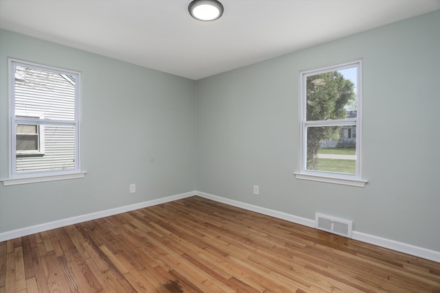 22029 Seminole St, Southfield, MI 48033 - empty room featuring baseboards, light wood finished floors, and visible vents
