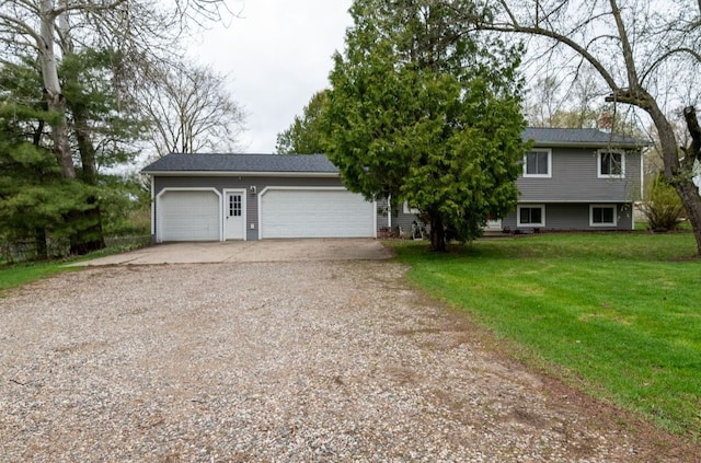 view of front facade with a garage, a front lawn, a chimney, and driveway
