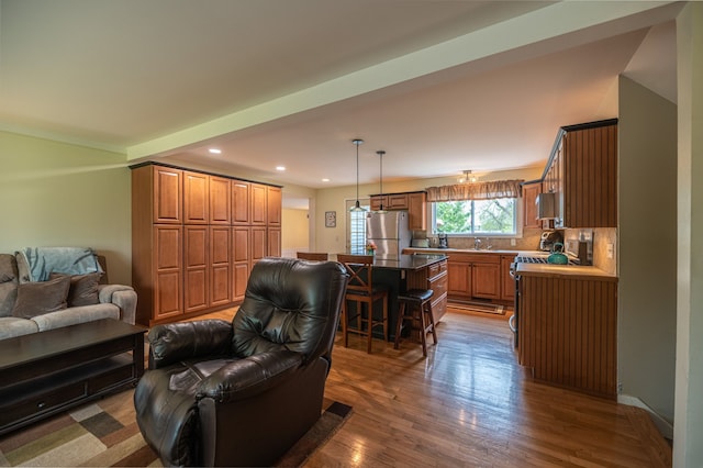 living room with dark wood finished floors and recessed lighting