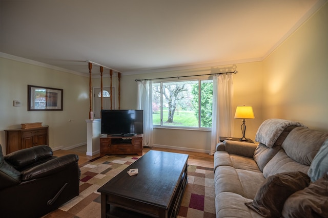 living area with baseboards, light wood-style flooring, and ornamental molding