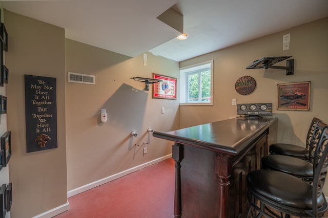 bar featuring baseboards, carpet flooring, and visible vents
