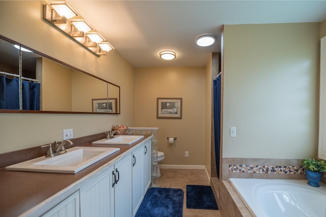 bathroom with double vanity, a relaxing tiled tub, tile patterned flooring, and a sink