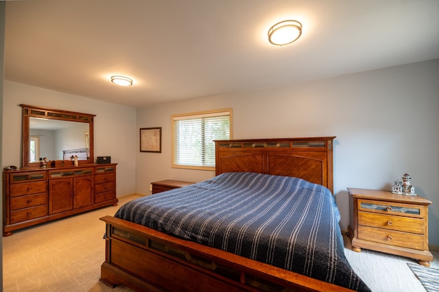 bedroom featuring light carpet