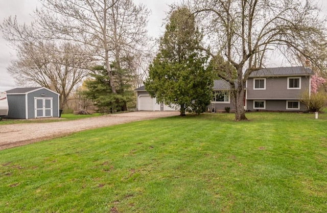 view of yard with an outdoor structure, a garage, a shed, and driveway
