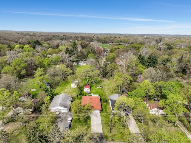 birds eye view of property with a view of trees