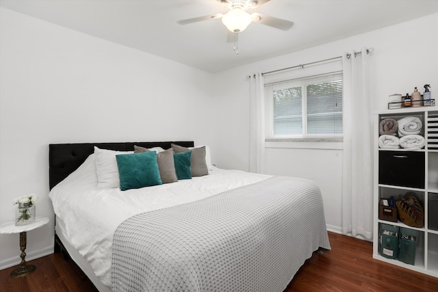 bedroom featuring baseboards, a ceiling fan, and wood finished floors