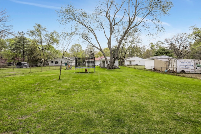 view of yard featuring a fenced backyard and a trampoline