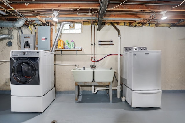 laundry room featuring a sink, electric panel, independent washer and dryer, and laundry area