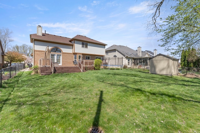 back of property with a fenced backyard, a trampoline, a shed, and a deck
