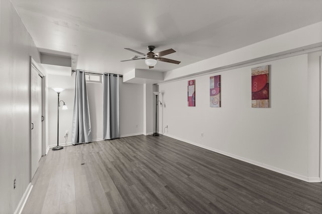 interior space with baseboards, ceiling fan, and wood finished floors