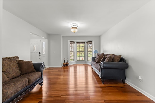 living room with baseboards and wood finished floors