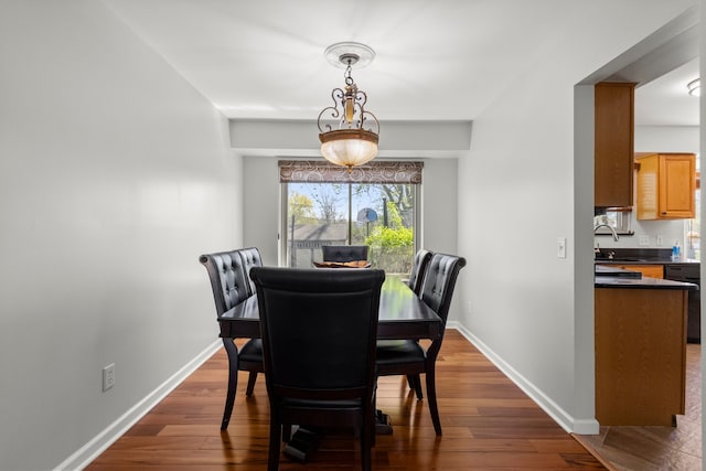 dining space with baseboards and dark wood-style floors