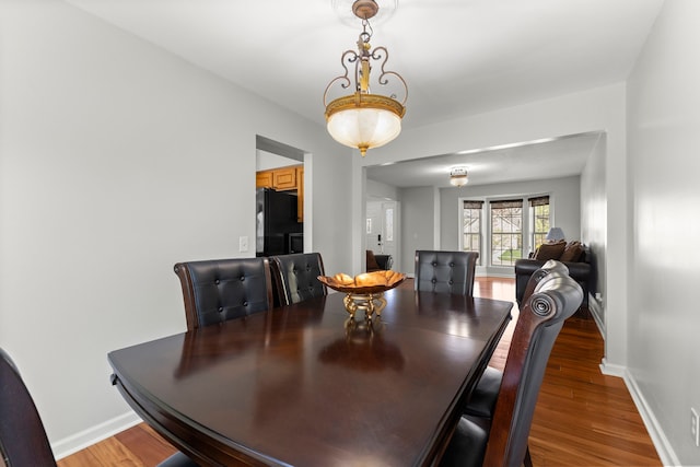 dining room featuring baseboards and wood finished floors