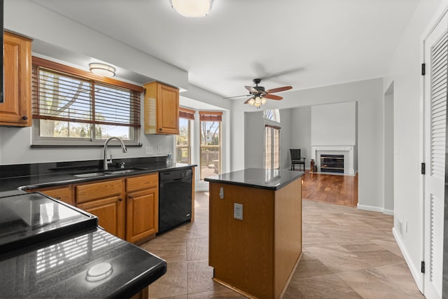 kitchen featuring ceiling fan, a center island, dark countertops, a sink, and black dishwasher