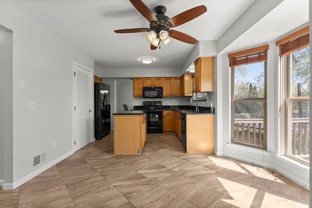 kitchen with a ceiling fan, dark countertops, baseboards, and black appliances