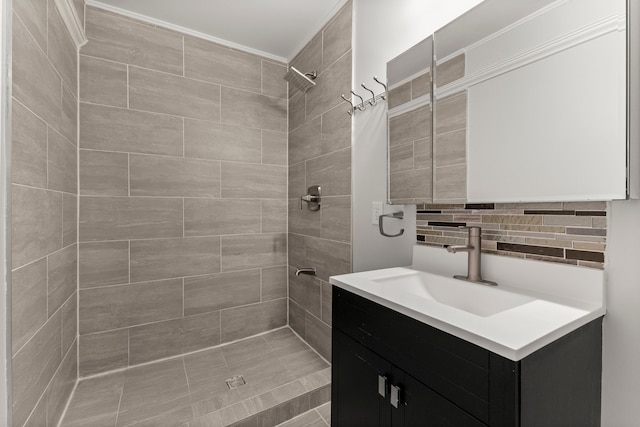 bathroom featuring vanity, backsplash, and tiled shower