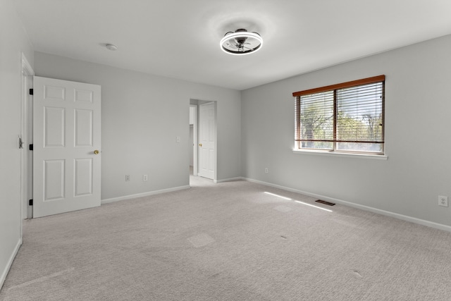 unfurnished bedroom with visible vents, carpet flooring, and baseboards