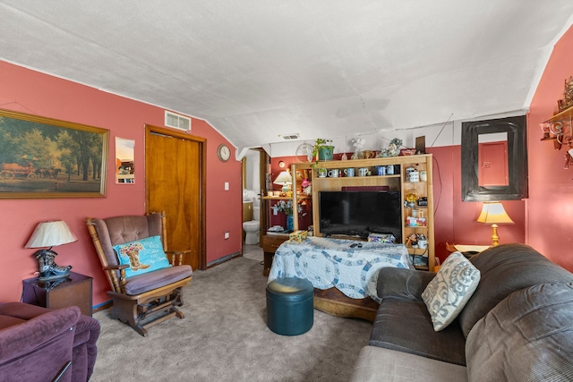 carpeted living room featuring visible vents and lofted ceiling