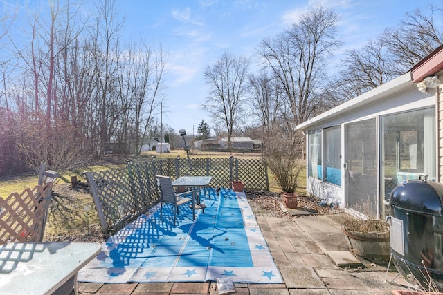 view of swimming pool with a sunroom, a patio area, fence, and a grill