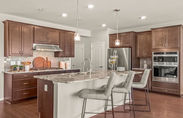 1569 Addison Cir, Walled Lake, MI 48390 - kitchen with backsplash, appliances with stainless steel finishes, a sink, dark wood-style floors, and under cabinet range hood