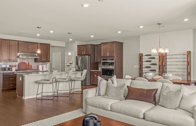 1569 Addison Cir, Walled Lake, MI 48390 - living room with dark wood-style flooring, an inviting chandelier, and recessed lighting