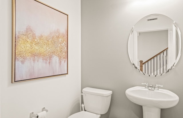 1569 Addison Cir, Walled Lake, MI 48390 - half bathroom featuring toilet, visible vents, and a sink