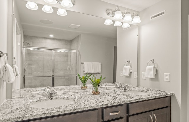 1569 Addison Cir, Walled Lake, MI 48390 - bathroom featuring a sink, a shower stall, double vanity, and visible vents