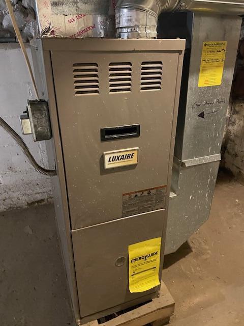 utility room with heating unit