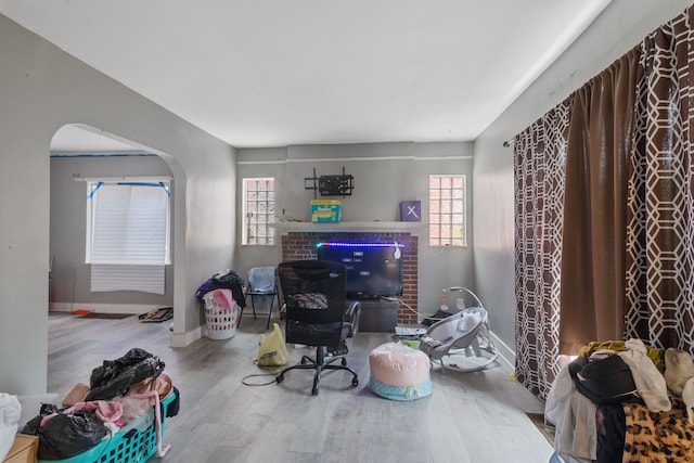 8690 Elmira St, Detroit, MI 48204 - living area featuring arched walkways, wood finished floors, plenty of natural light, and baseboards