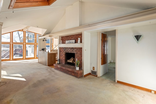 unfurnished living room with carpet floors, a fireplace, high vaulted ceiling, and visible vents