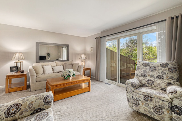 carpeted living room with visible vents and baseboards