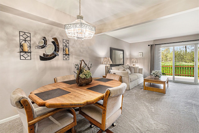 dining room featuring baseboards, a notable chandelier, and carpet