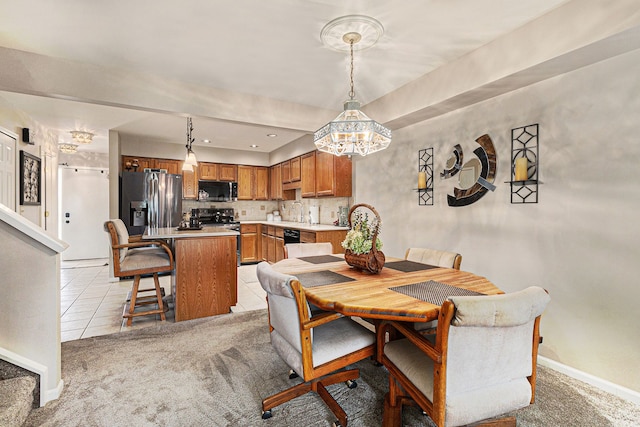 dining room featuring an inviting chandelier, light tile patterned floors, baseboards, and light carpet