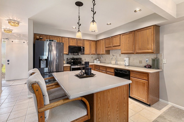 kitchen with a breakfast bar area, tasteful backsplash, a sink, appliances with stainless steel finishes, and light tile patterned floors