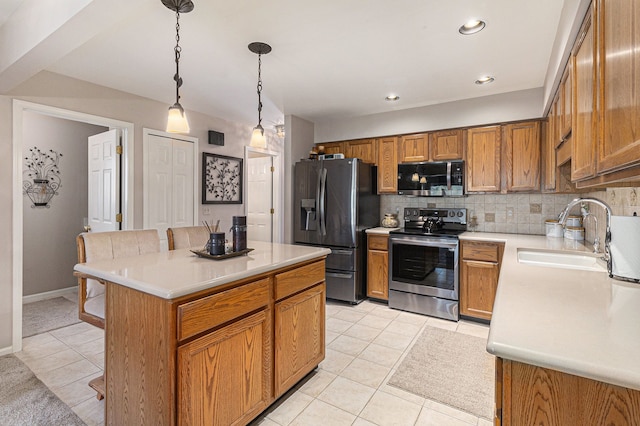 kitchen with a kitchen bar, appliances with stainless steel finishes, tasteful backsplash, a sink, and light tile patterned floors