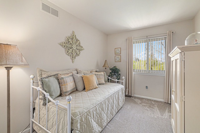 bedroom with visible vents, baseboards, and light colored carpet