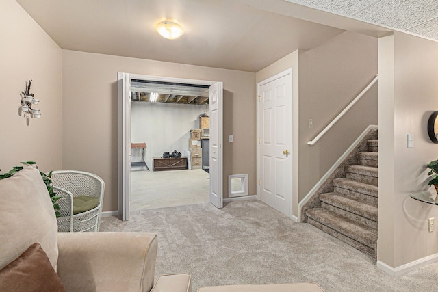 living area with carpet floors, baseboards, and stairs