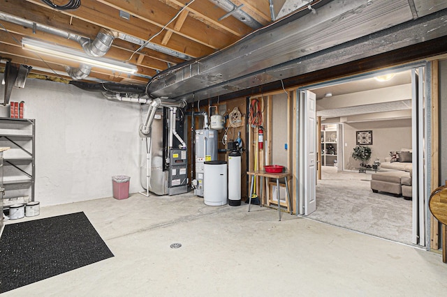 unfinished below grade area featuring heating unit and gas water heater