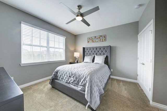 carpeted bedroom featuring a ceiling fan and baseboards