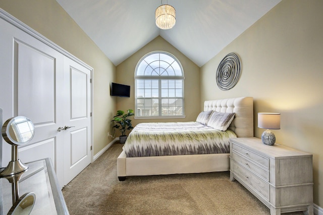 carpeted bedroom featuring baseboards and vaulted ceiling