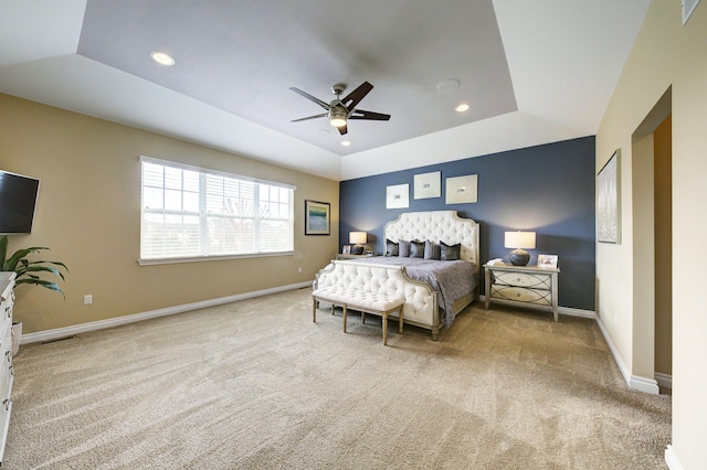 carpeted bedroom featuring recessed lighting, baseboards, ceiling fan, and a raised ceiling