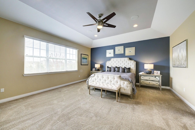 carpeted bedroom with recessed lighting, baseboards, a ceiling fan, and a tray ceiling