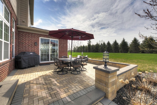 view of patio / terrace with outdoor dining space and a grill